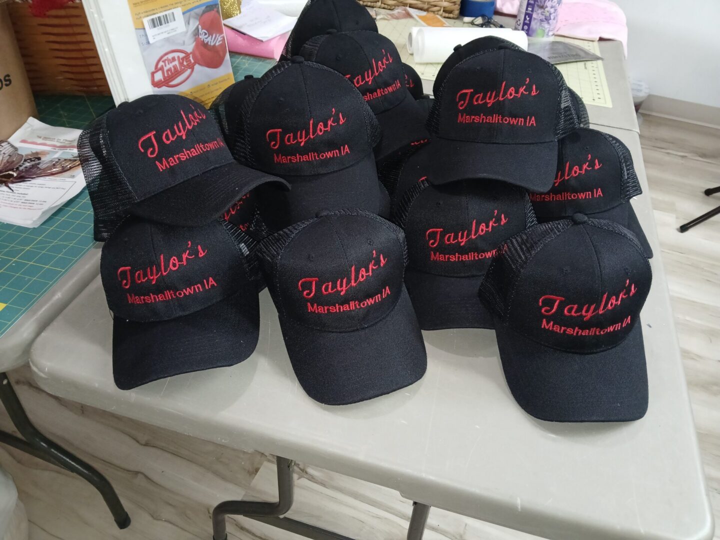 Black baseball caps embroidered "Taylor's Marshalltown IA