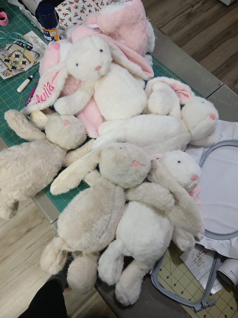 Pile of plush white and pink stuffed bunnies