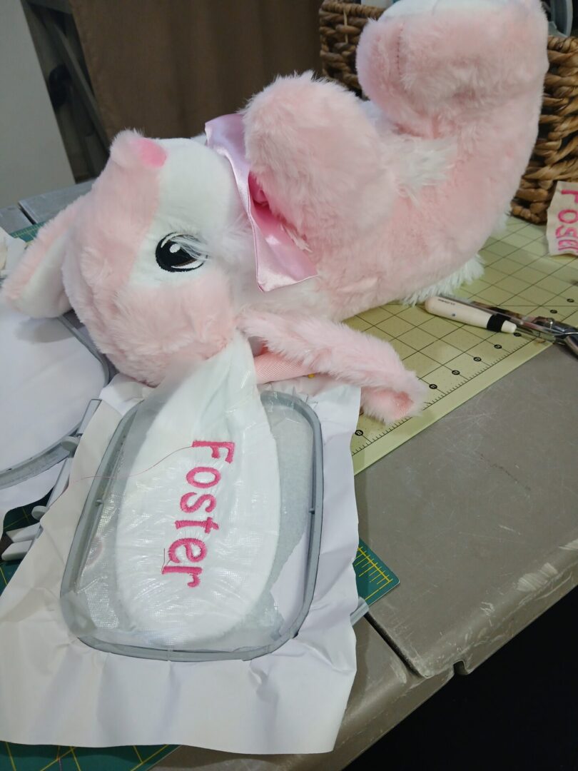 Pink plush bunny and embroidered shoe insole