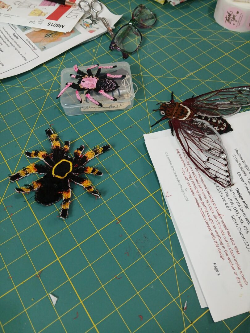 Beaded insect and spider crafts on cutting mat
