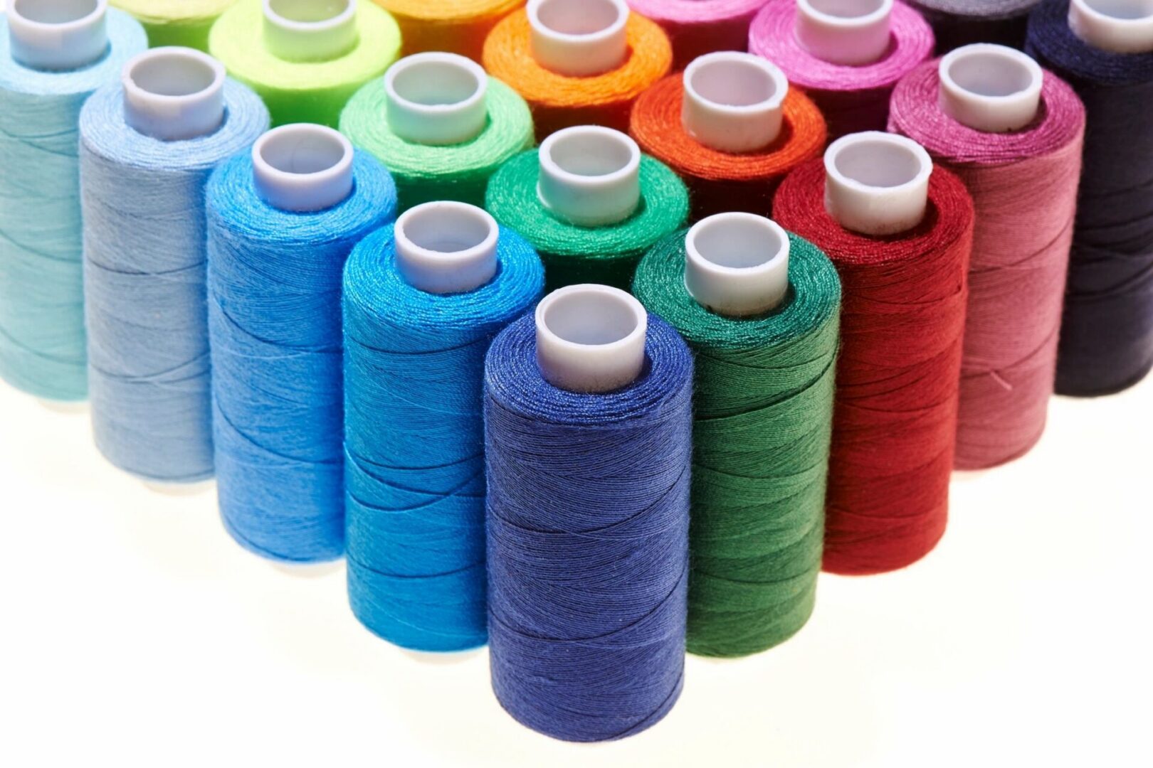 Rows of colorful sewing thread spools