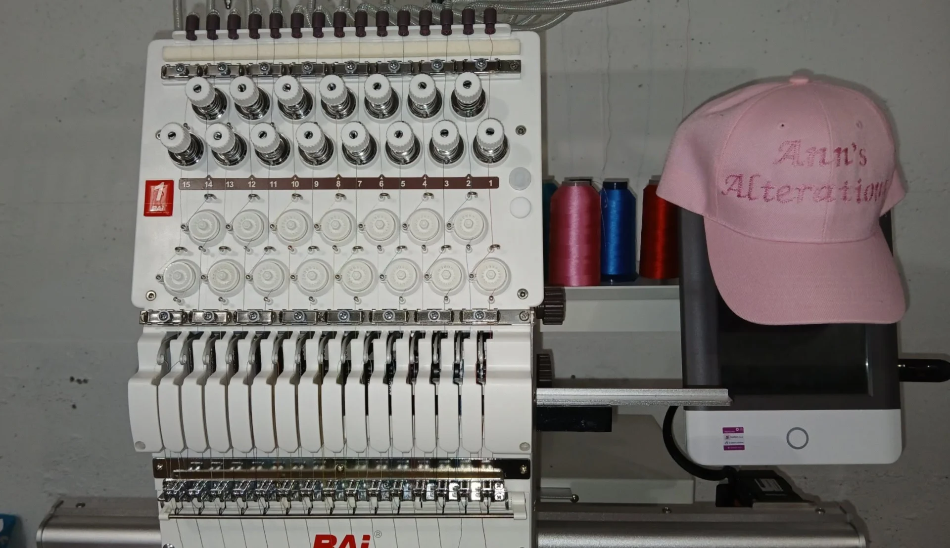 Embroidery setup featuring a pink hat
