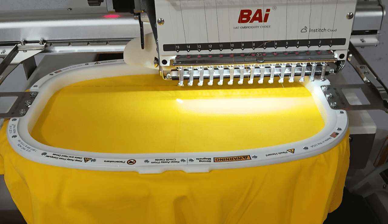 Embroidery machine working on yellow fabric